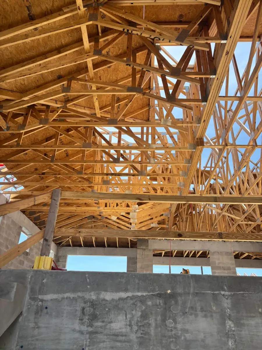 Newly framed roof trusses and sheathing over a concrete block wall on a Southwest Florida new build